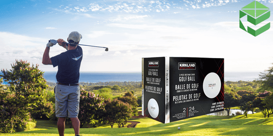 A golfer swings on a scenic golf course with an ocean view, while a box of Kirkland Signature Golf Balls is prominently displayed in the foreground. The packaging highlights the 3-piece urethane cover and performance features.